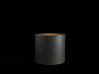 Minimalist dark gray cylinder with warm glowing interior against black background