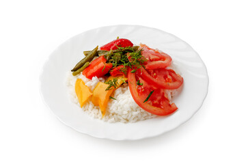 Colorful rice dish with fresh vegetables and herbs on a white plate