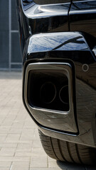 Close view of a modern car exhaust with shiny detailing and unique design elements