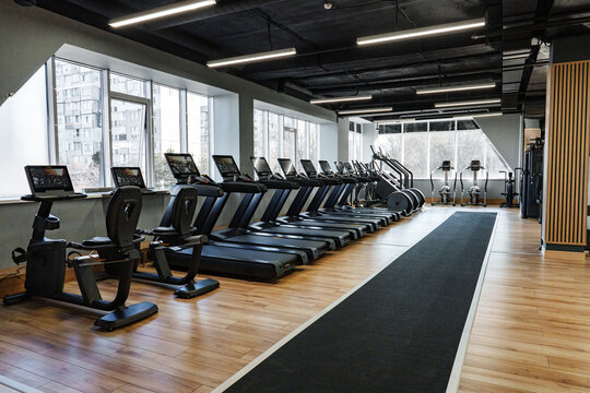 Modern gym interior with exercise equipment in a spacious fitness center