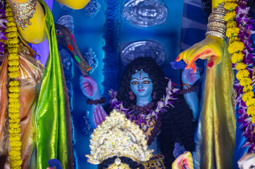 Fototapeta premium A beautifully crafted handmade colorful goddess durga idol decorated for Navratri, featuring vibrant traditional attire, intricate jewellery, and divine expressions at colorful pandal.