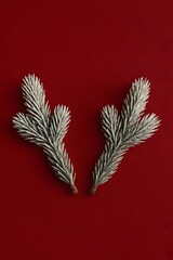 Vertical Christmas Still Life with Frosted Pine Reindeer Antlers on Deep Red Background