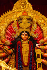 Fototapeta premium A beautifully crafted handmade colorful goddess durga idol decorated for Navratri, featuring vibrant traditional attire, intricate jewellery, and divine expressions at colorful pandal.