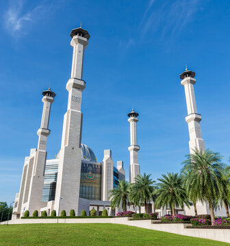 Balai Khazanah Islam Sultan Haji Hassanal Bolkiah, Islamic Treasury, Bandar Seri Begawan, Brunei. Modern Islamic architecture with minarets, dome, and palm trees under a blue sky