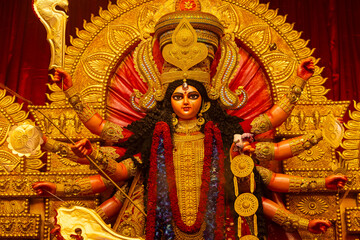 Fototapeta premium A beautifully crafted handmade colorful goddess durga idol decorated for Navratri, featuring vibrant traditional attire, intricate jewellery, and divine expressions at colorful pandal.