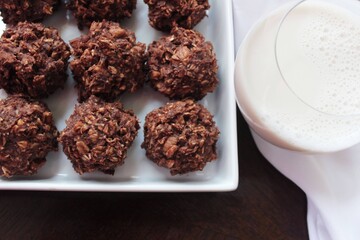 Bake Chocolate Oatmeal Cookies with Peanut Butter and Milk on a White Plate