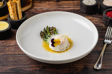 Poached egg served with asparagus and buttery golden sauce
