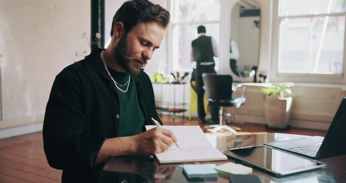 Technology, barber and man writing in notebook for daily operations, to do list and thinking of agenda. Entrepreneur, productivity plan and people in hair salon with service reflection, tablet and pc