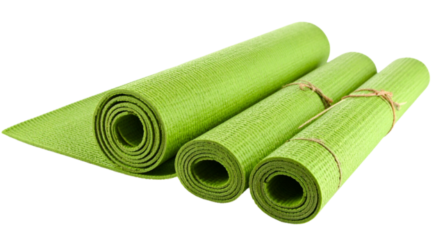 Close-up of three green, rolled, textured exercise mats, one unrolled, on black