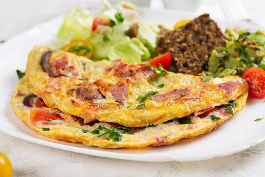 Omelette with ham and vegetables. Healthy breakfast.