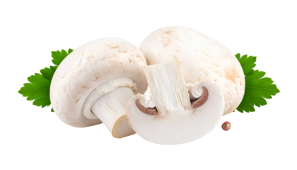 Close-up studio shot of three white mushrooms, one cut in half, with green leaves