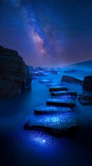 Night Seascape with Starry Sky and Milky Way Over Rocky Shore in Blue Tones