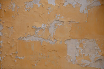 Old wall texture featuring cracks, stains and uneven plaster; suitable for digital art, graphic design and restoration projects.