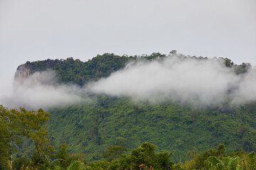 Scenic view of morning fog across mountain in rainy season © Cavan