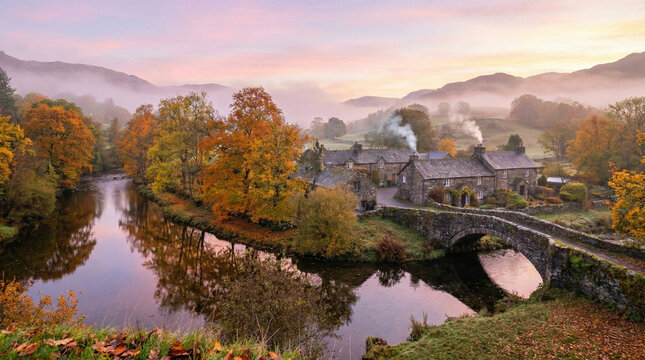 Autumn sunrise over stone cottages and an old bridge, misty river landscape with vibrant fall colors and morning fog in the countryside