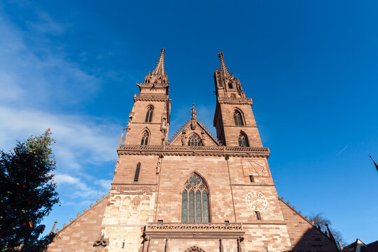 Close-up of the impressive red sandstone facade and twin Gothic spires of the Basel Minster cathedral