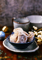 Traditional christmas cookies in a bowl on a rustic wooden background. Soft focus.	