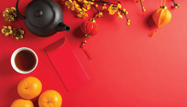 chinese new year flat lay composition with teapot red envelopes oranges lanterns golden flowers on red background