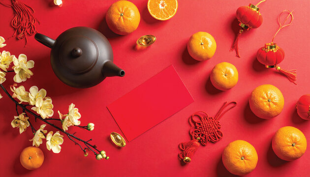 chinese new year flat lay composition with teapot red envelopes oranges lanterns golden flowers on red background - Powered by Adobe