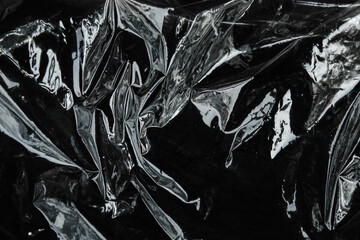 crumpled plastic wrap texture on black background