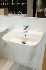 Modern white semi-recessed bathroom sink with chrome faucet display
