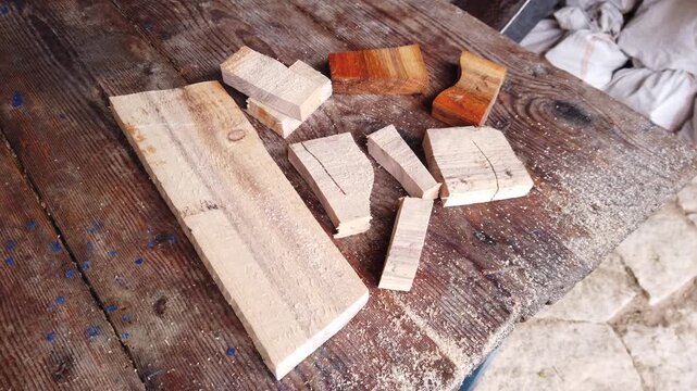 Still video of pieces of wood after cutting with electric cordless jigsaw