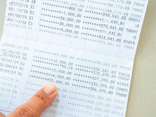 Obraz premium Bank account book statement balance number cash, hand holding data investment debt math in office, bill receipt and payment business credit card account, check paper financial loan tax concept.