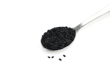 Black sesame seeds on spoon white background