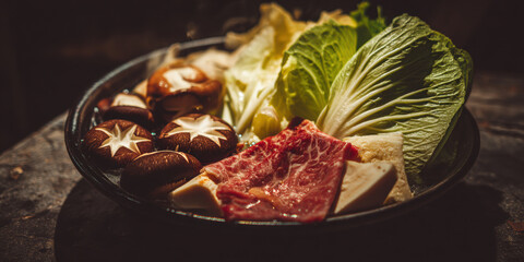 Steaming hot pot with fresh vegetables and mushrooms, ready to eat. A delicious and healthy meal is ready to be enjoyed, featuring fresh ingredients and flavorful broth.