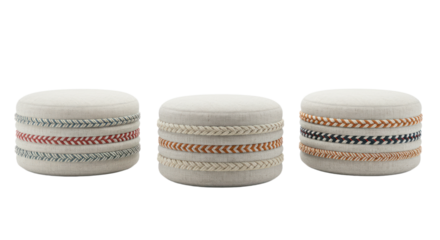 Set of three round upholstered fabric poufs or ottomans with colorful braided rope details, isolated on a black background