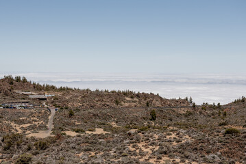 A winding road leads into the heart of Tenerifes mountainous region, surrounded by unique flora and a breathtaking sky