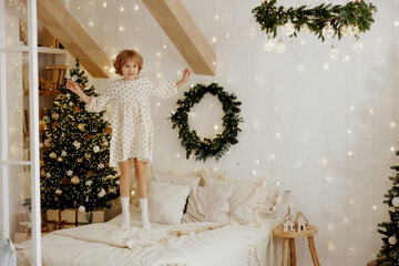 Joyful Child Jumping on Bed in Cozy Christmas Decorated Room