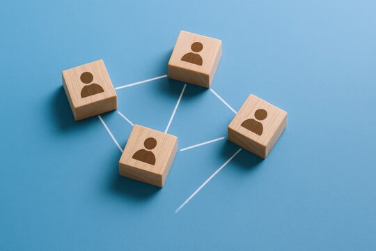 Network Concept with Wooden Blocks and People Icons Connecting on Blue Background Symbolizing Collaboration