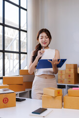 Young woman managing online store checking shipping orders