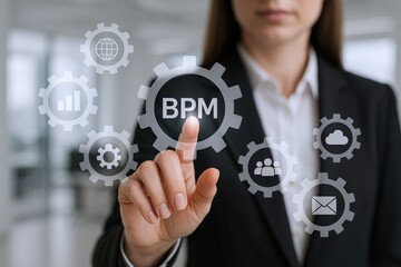 Business process management concept: Woman pointing at BPM icon on virtual screen, symbolizing workflow optimization