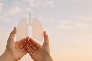 Hands Holding Lung Shape Against Sky: Symbol of Respiratory Health and Pulmonary Awareness