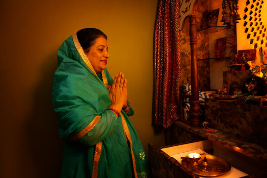 A mother prays at the home temple during the family�s morning ritual