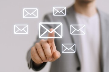 Man touching digital email icons, representing communication, marketing campaigns, and modern technology in business