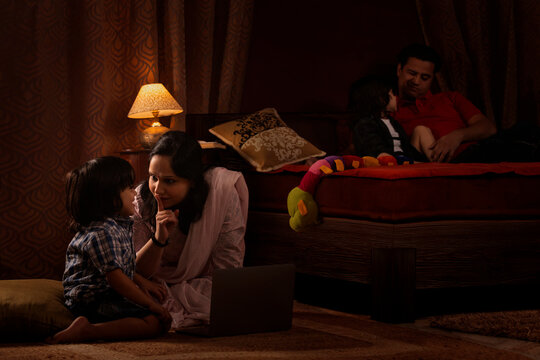 Parents spending fun times with their kids in bedroom