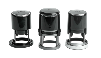 Three self-inking, office-style stamps, various metallic accents, displayed against a black background