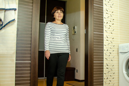 elderly woman entering through bathroom doorway, beginning her morning or evening skincare ritual - Powered by Adobe