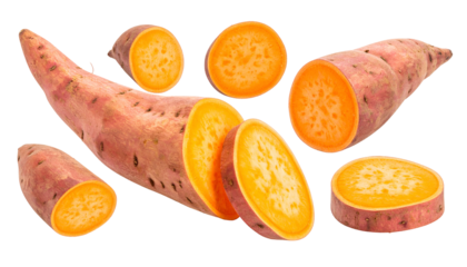 Assorted cut and whole tubers with orange flesh and pinkish-brown skin against a black backdrop