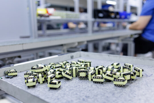 Electronic transformers on tray at power electronics assembly line