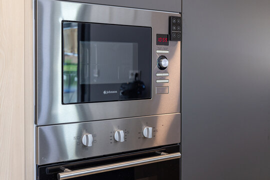 Built-in stainless steel microwave and oven combination in modern kitchen