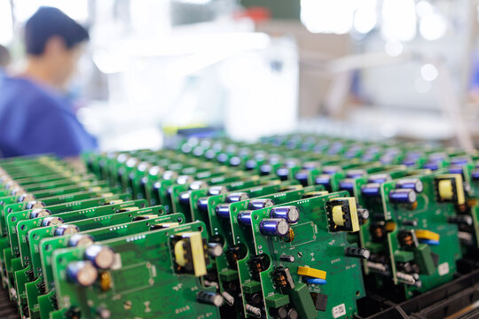 Rows of assembled electronic circuit boards at electronics manufacturing factory