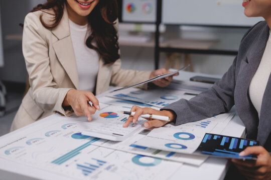 Businesswomen analyzing financial data and planning strategy - Powered by Adobe