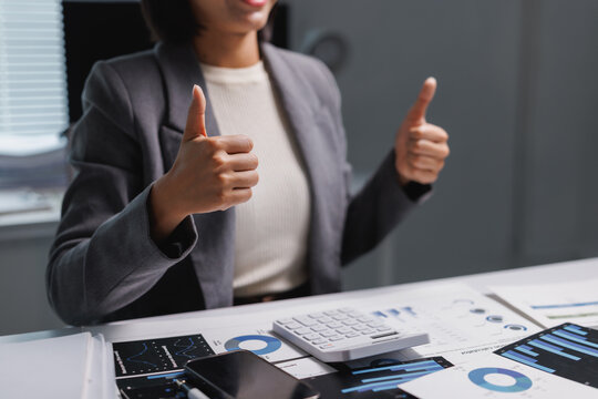 Young professional showing two thumbs up for business success