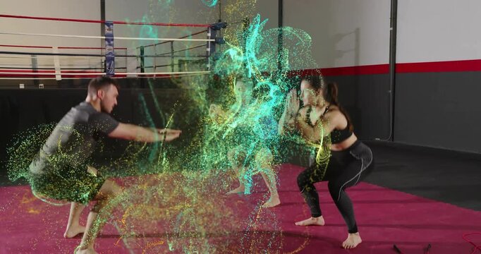 Male coach leading squats by raising arms on red gym mat, women following while particles swirling