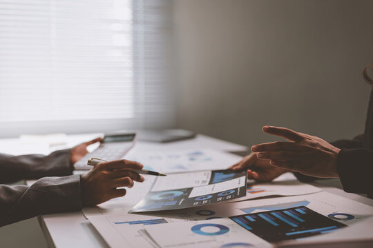 Business people analyzing financial data reporting during meeting