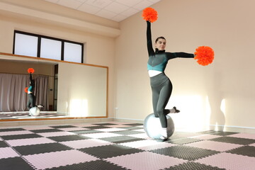 Beautiful girl doing cheerleading and pom pom dance training